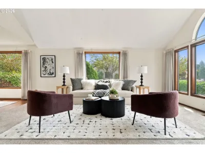 Staged living room under the arched window in a home staged by Willow & Fern