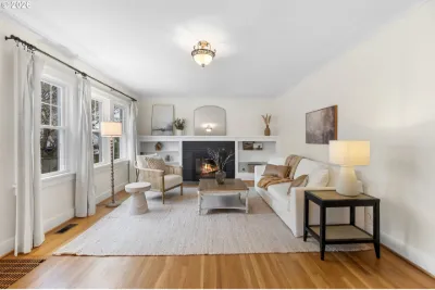 Cottage living room staged with cream sofas, a fireplace and white built-ins